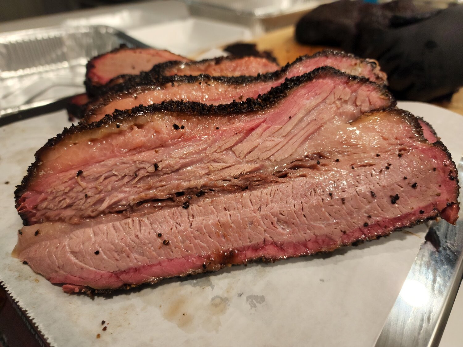 Sliced brisket showing the smoke ring and peppered bark