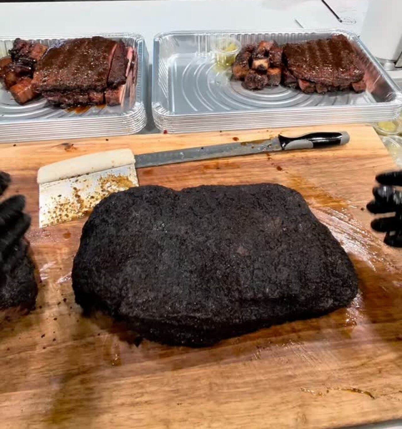 A whole smoked brisket resting on the board