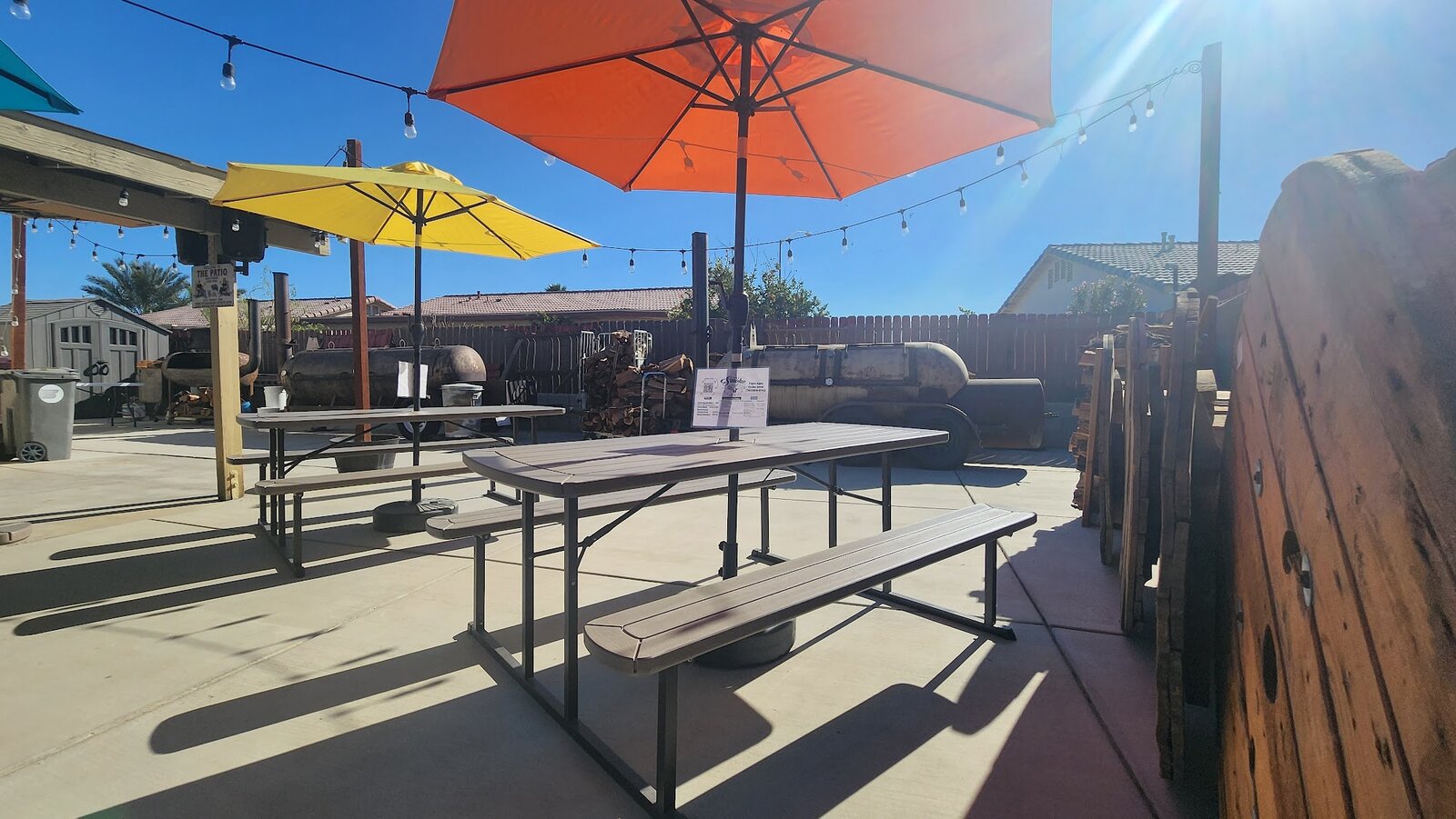 The pickup patio, umbrellas and the smoker