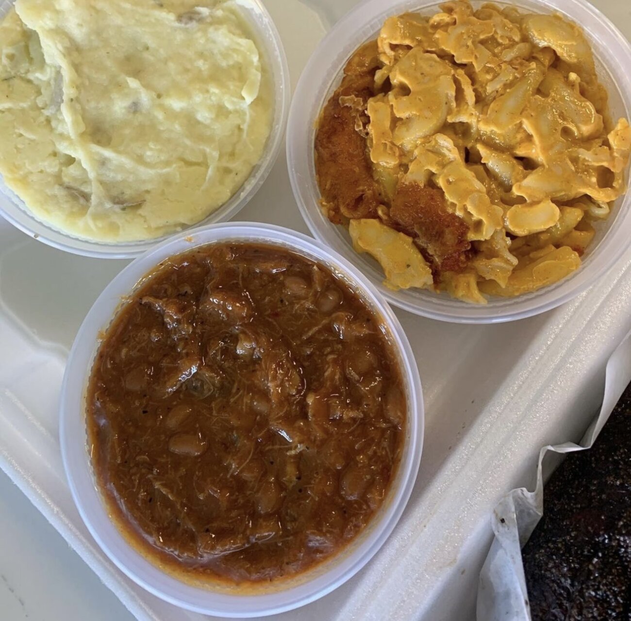 Mashed potatoes, smoked mac and cheese and loaded beans in tubs